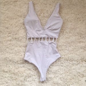 BRAND NEW! White one piece with sexy cut outs!